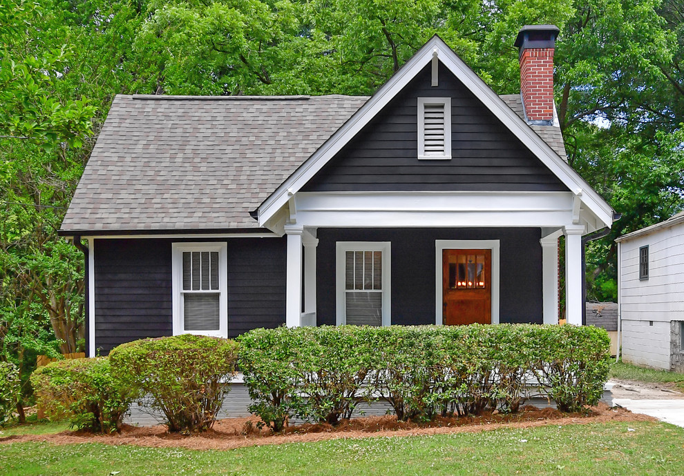 Inspiration for a black traditional house exterior in Atlanta with a pitched roof and a shingle roof.