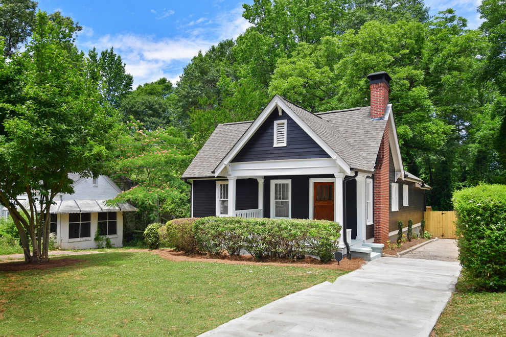 This is an example of a black classic house exterior in Atlanta with a pitched roof and a shingle roof.