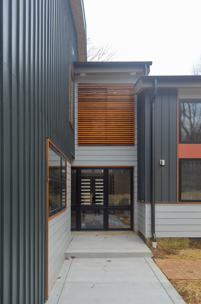 Large minimalist black two-story mixed siding exterior home photo in DC Metro with a hip roof