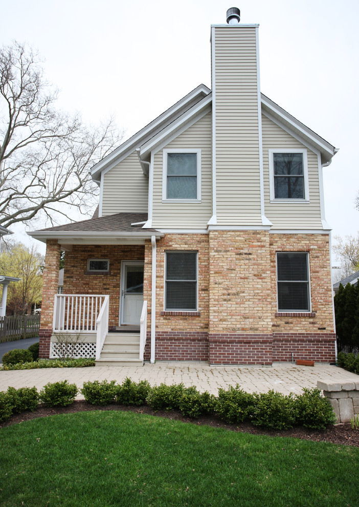 Inspiration for a large timeless beige two-story mixed siding gable roof remodel in Chicago