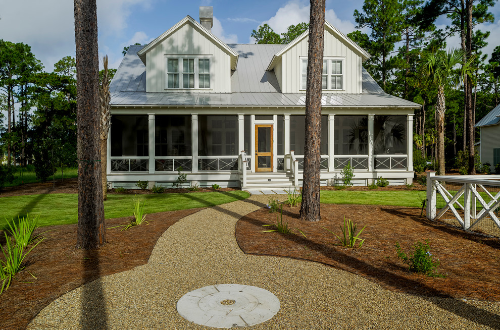 Photo of a white and large traditional two floor house exterior in Charleston with wood cladding.