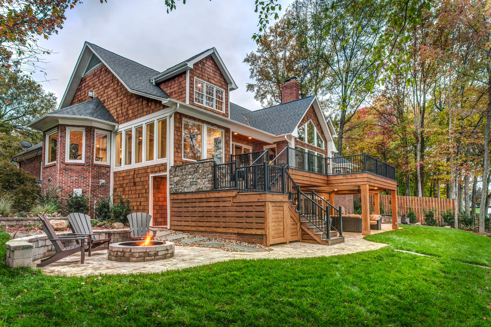 Large mountain style brown three-story wood gable roof photo in Charlotte