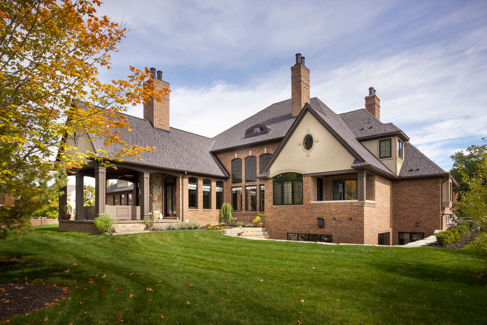 Photo of an expansive and brown rustic house exterior in Detroit with three floors and mixed cladding.