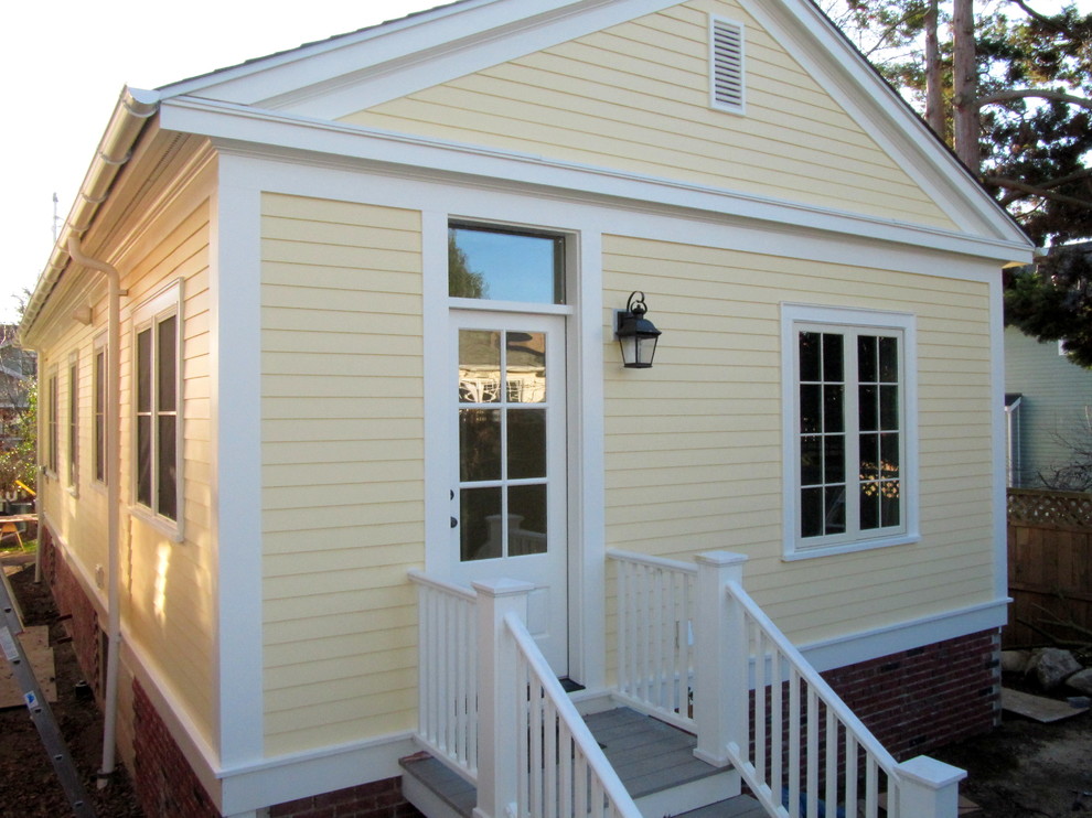 Kleines, Einstöckiges Klassisches Haus mit Faserzement-Fassade, gelber Fassadenfarbe und Satteldach in Seattle
