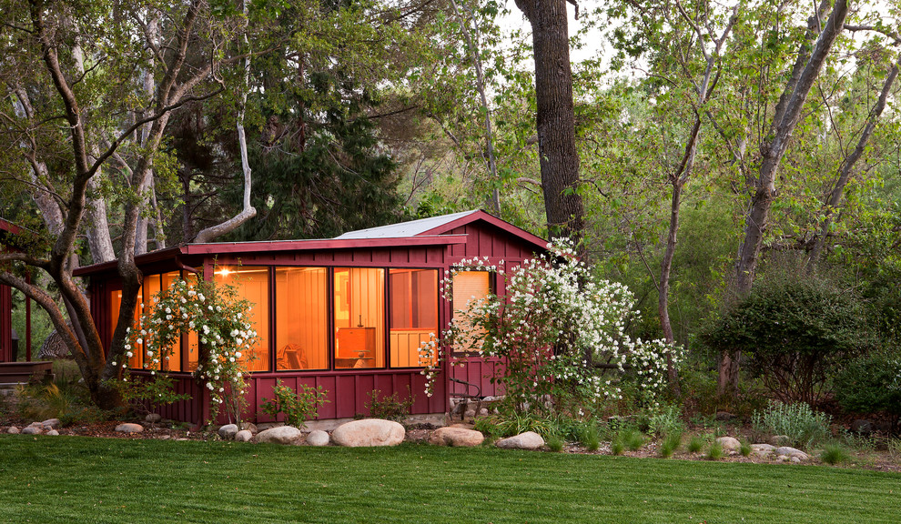Design ideas for a small and red rustic bungalow house exterior in Los Angeles with wood cladding.