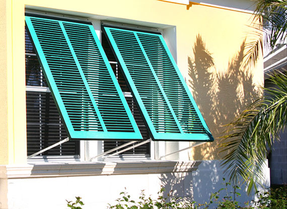 Example of a mid-sized transitional yellow two-story mixed siding house exterior design in Charleston with a hip roof