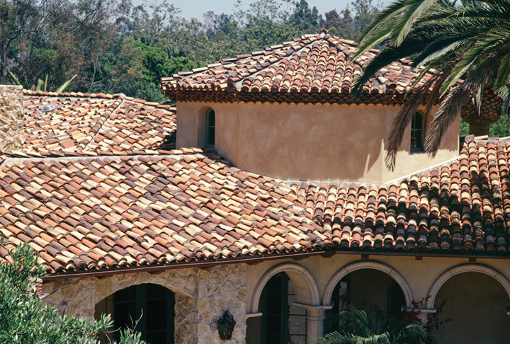 Photo of a medium sized and beige mediterranean two floor render detached house in San Diego with a hip roof and a tiled roof.