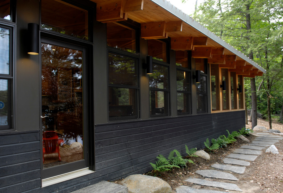 Example of a large trendy black two-story wood exterior home design in Toronto