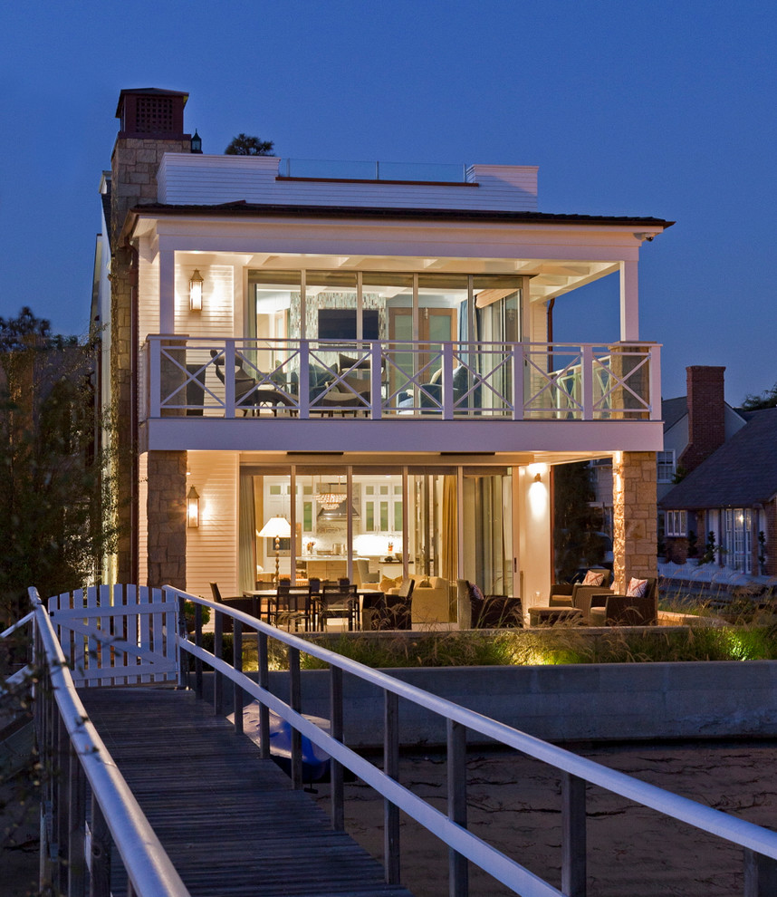 This is an example of a large and white nautical two floor house exterior in Orange County.