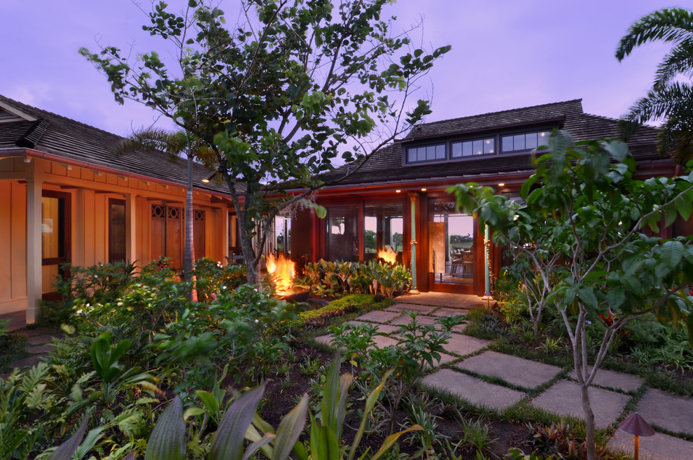 Photo of an expansive and brown world-inspired two floor house exterior in Hawaii.
