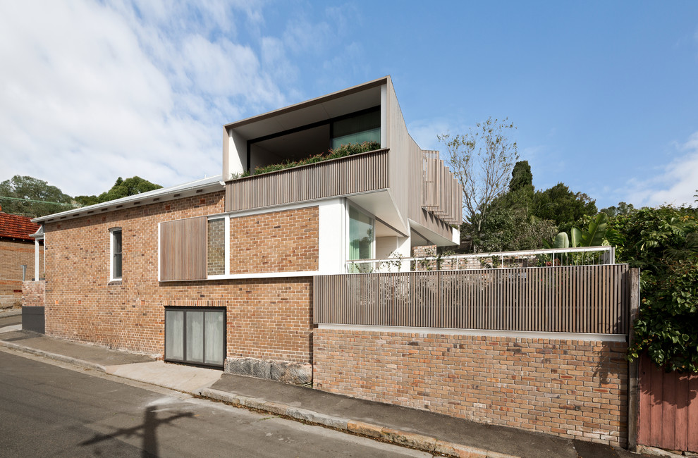 Contemporary brick house exterior in Sydney with three floors.