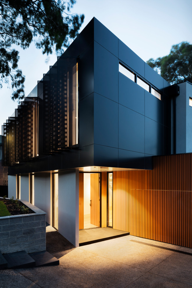 Example of a large trendy black two-story metal exterior home design in Melbourne with a metal roof