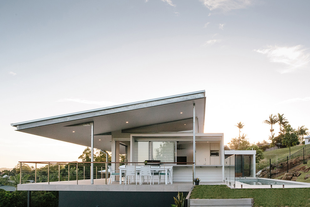 Idée de décoration pour une grande façade de maison blanche minimaliste de plain-pied avec un revêtement en vinyle.