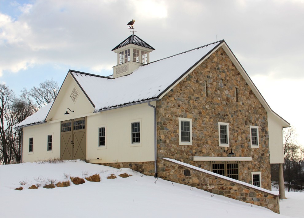 Foto della villa beige country a due piani di medie dimensioni con rivestimento in pietra, tetto a capanna e copertura in metallo o lamiera