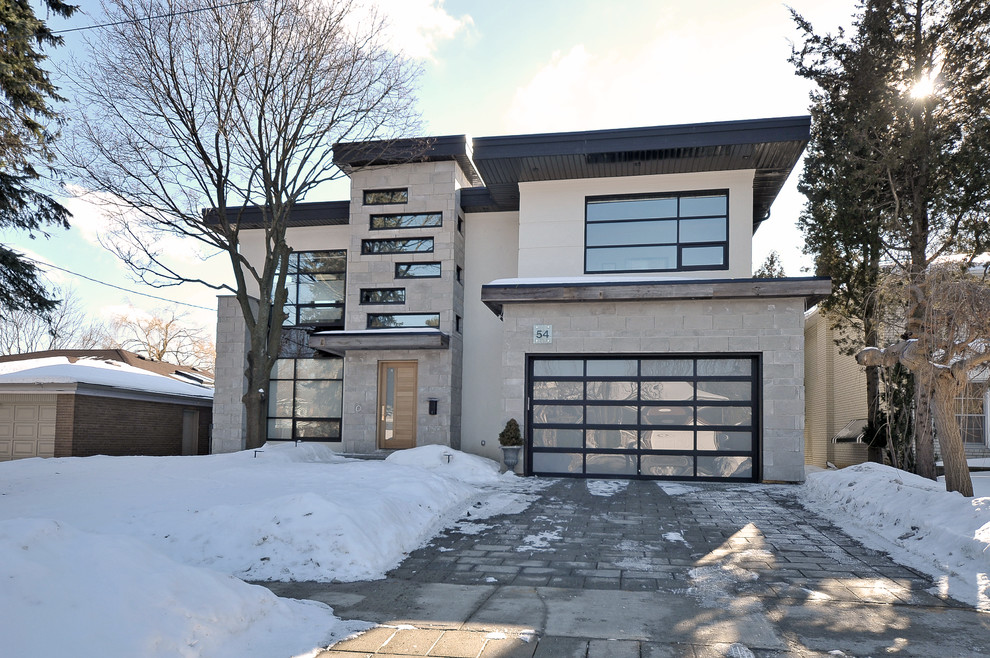 This is an example of a medium sized and gey contemporary two floor house exterior in Toronto with mixed cladding.