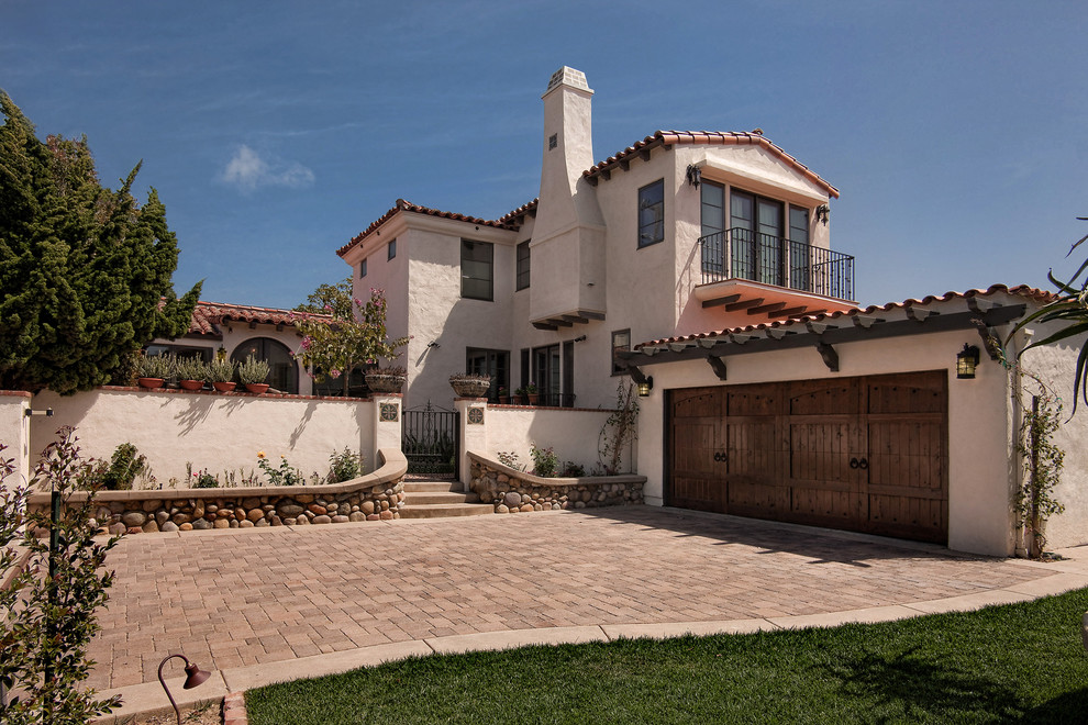 Tuscan white split-level stucco exterior home photo in San Diego