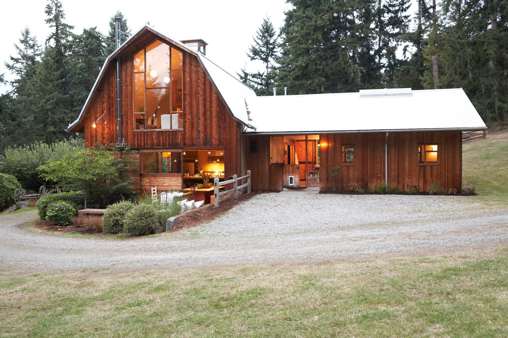 This is an example of a rural two floor house exterior in Seattle with wood cladding.