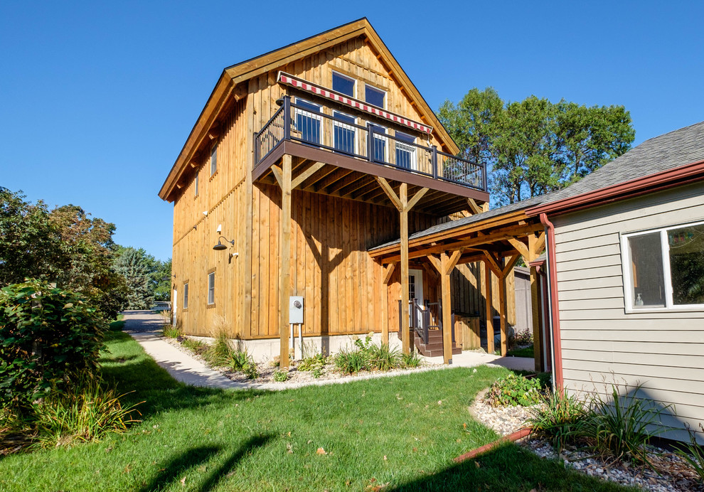Idee per la facciata di una casa grande marrone rustica a due piani con rivestimento in legno e tetto a capanna