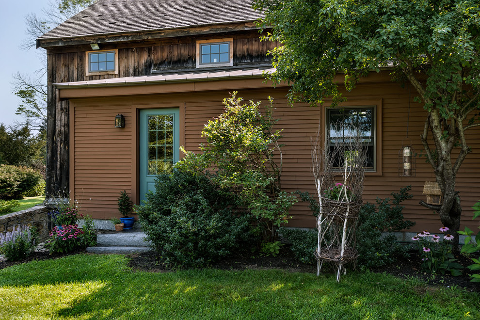 Example of a farmhouse exterior home design in Boston