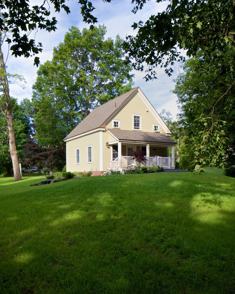 This is an example of a yellow farmhouse two floor house exterior in Portland Maine.