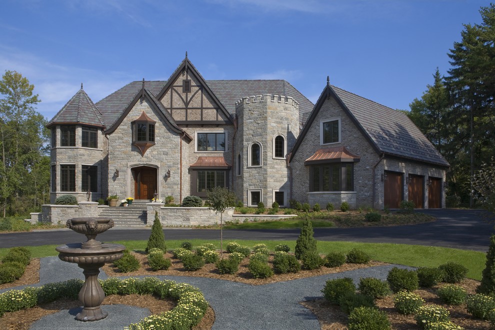 Elegant two-story stone exterior home photo in Milwaukee