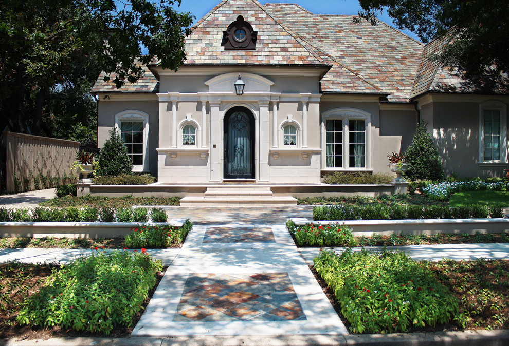 This is an example of a beige and medium sized classic two floor house exterior in Dallas with mixed cladding and a pitched roof.