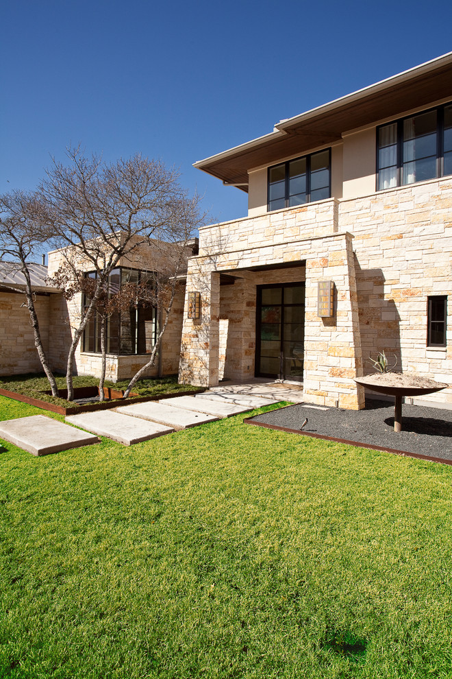 Photo of a contemporary house exterior in Austin with stone cladding.