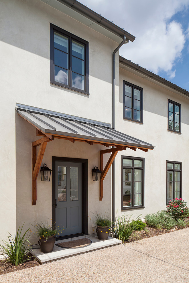 Inspiration for a mid-sized timeless white two-story stucco exterior home remodel in Austin