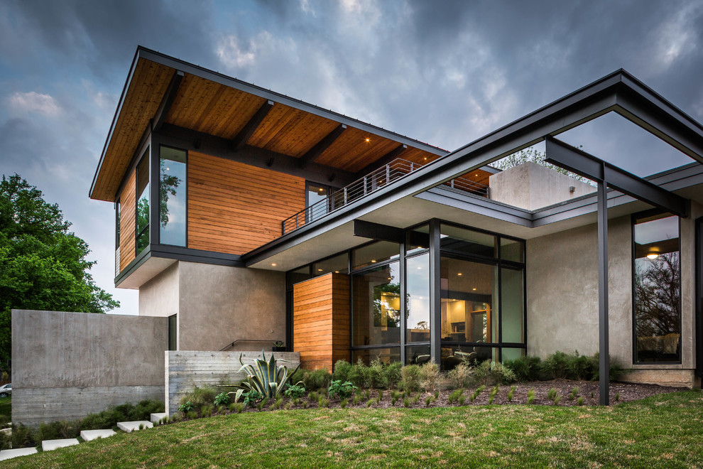 Design ideas for a gey contemporary two floor house exterior in Austin with wood cladding.