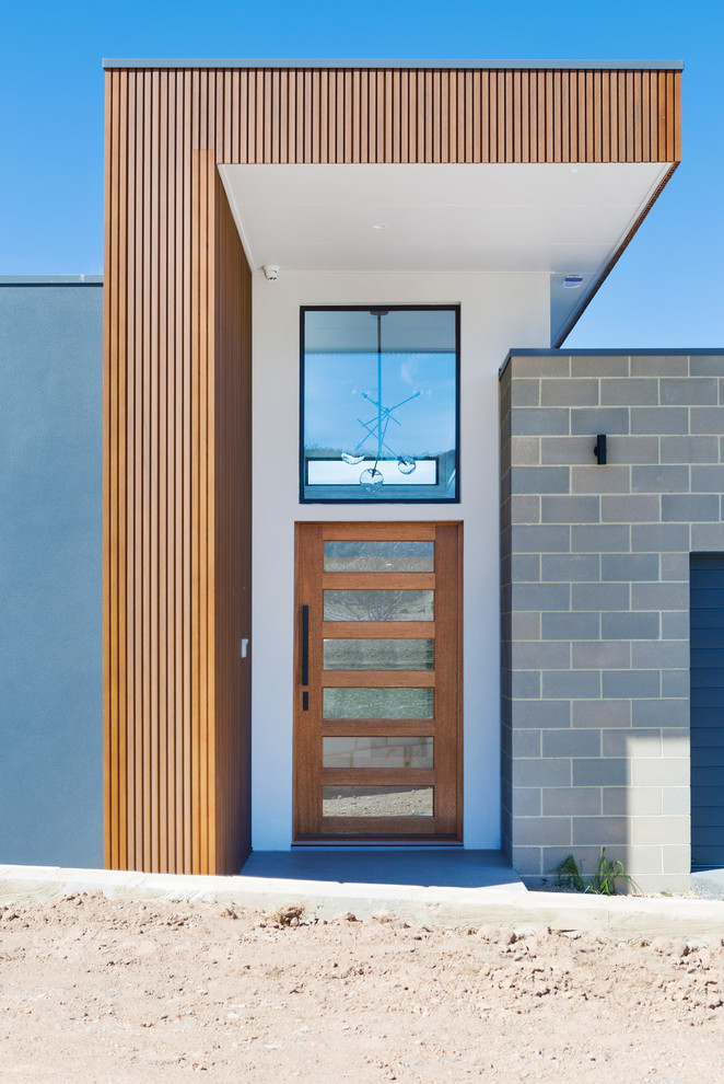 Стильный дизайн: большой, одноэтажный, синий частный загородный дом в современном стиле с облицовкой из бетона, плоской крышей и металлической крышей - последний тренд