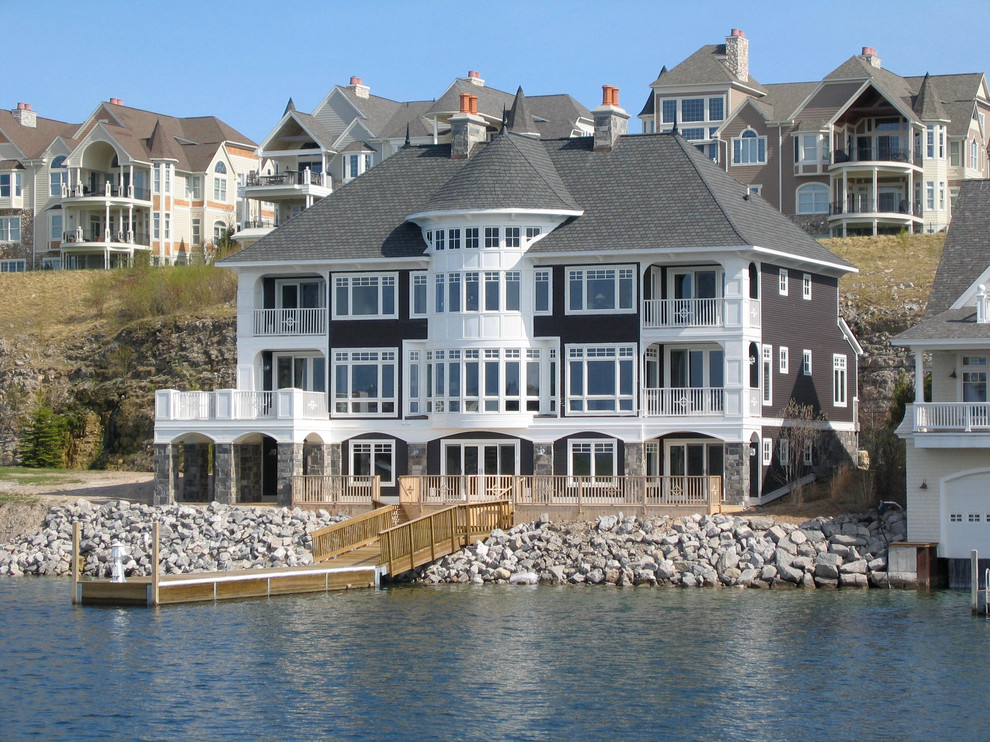 Design ideas for a nautical house exterior in Grand Rapids with three floors.
