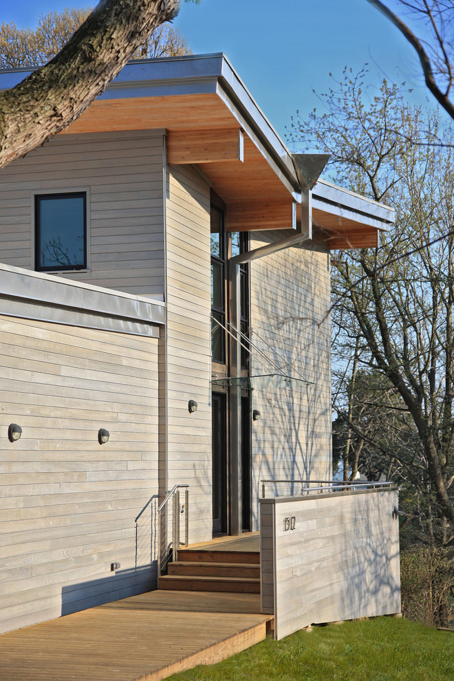 Photo of a contemporary house exterior in DC Metro with wood cladding.