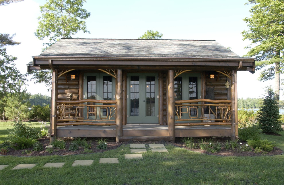 Small and brown rustic bungalow house exterior in Minneapolis with wood cladding and a pitched roof.