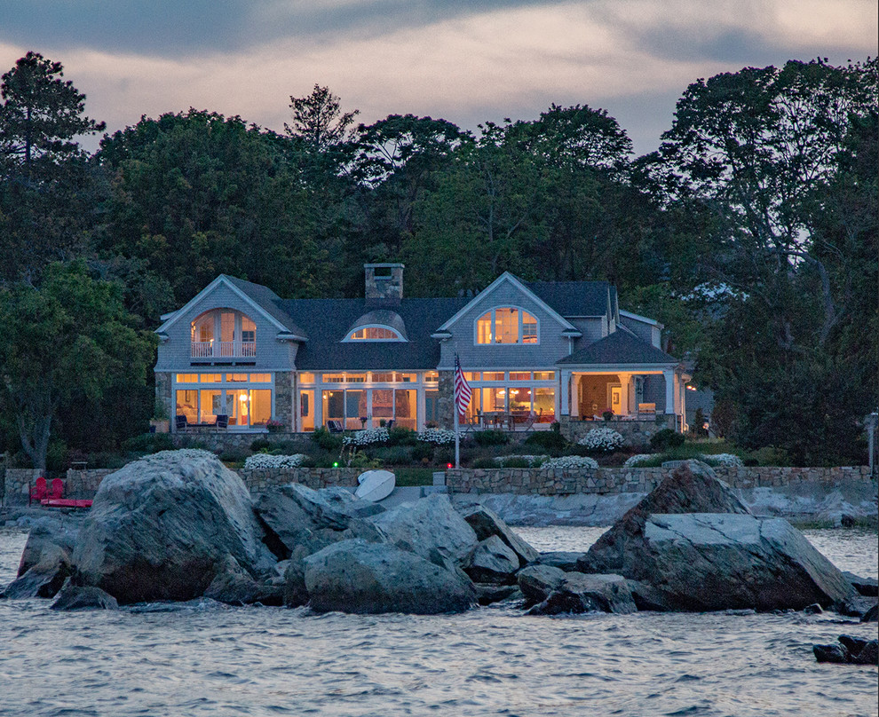 Example of a large beach style gray two-story wood exterior home design in Boston with a shingle roof