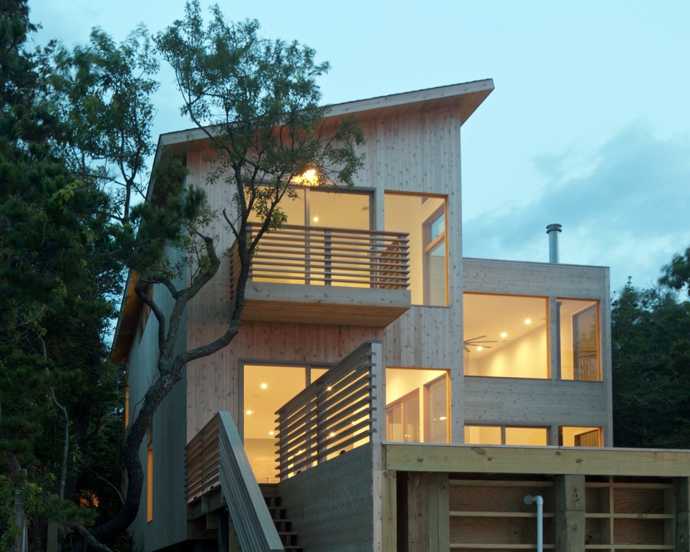 Medium sized and beige modern two floor detached house in New York with wood cladding, a lean-to roof and a green roof.