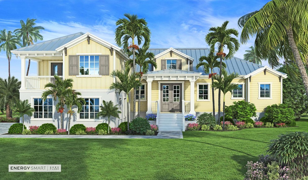 На фото: двухэтажный, желтый частный загородный дом среднего размера в морском стиле с комбинированной облицовкой, вальмовой крышей и металлической крышей с