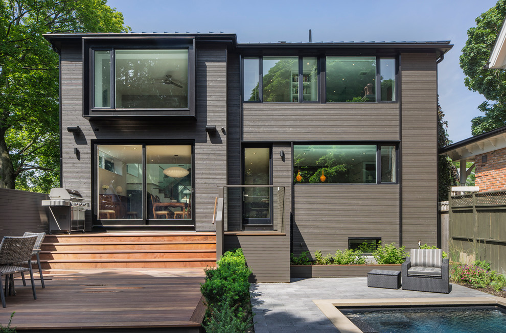 Inspiration for a medium sized and brown contemporary two floor house exterior in Toronto with wood cladding.