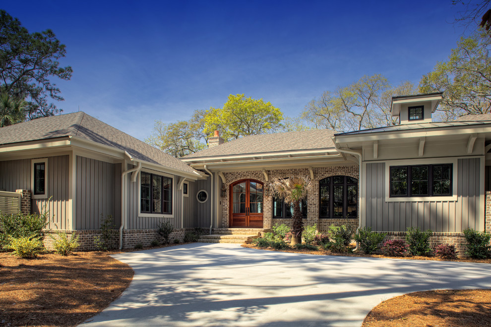 This is an example of a large and beige beach style bungalow house exterior in Charleston.