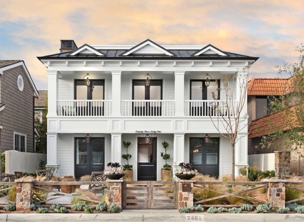 Example of a mid-sized transitional white two-story wood exterior home design in Orange County