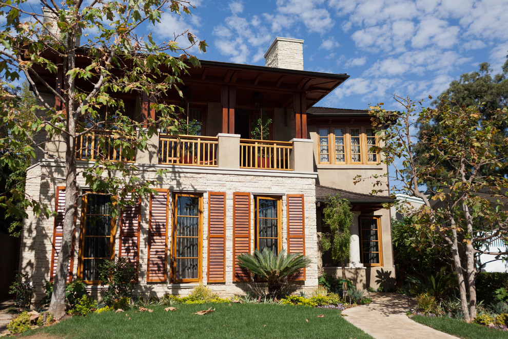 This is an example of a mediterranean two floor house exterior in Orange County.