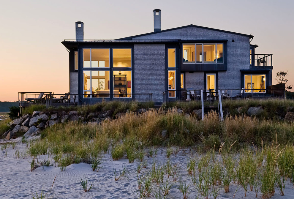 Example of a beach style two-story wood exterior home design in Portland Maine