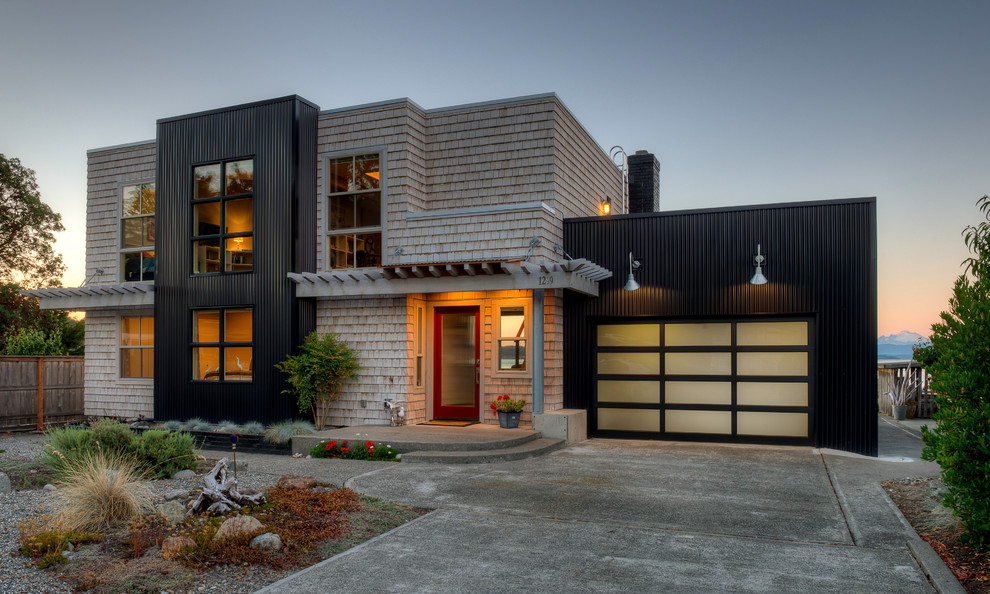 Design ideas for a coastal two floor house exterior in Seattle with wood cladding and a flat roof.