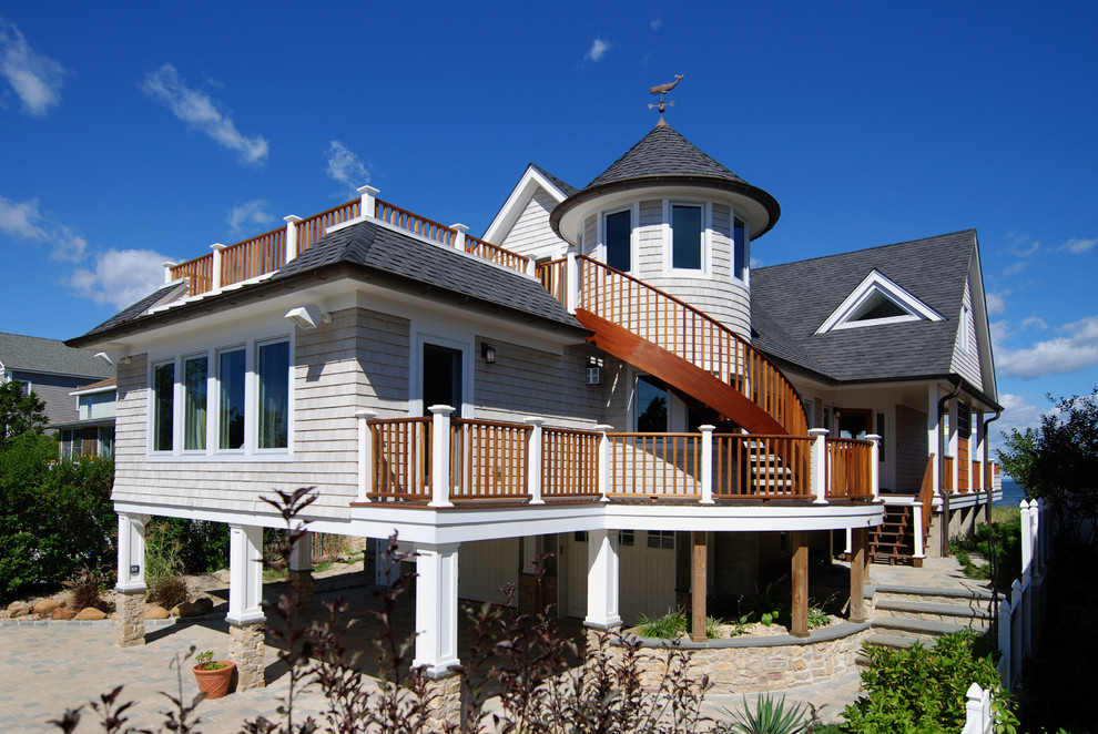Inspiration for a nautical house exterior in Huntington with wood cladding.