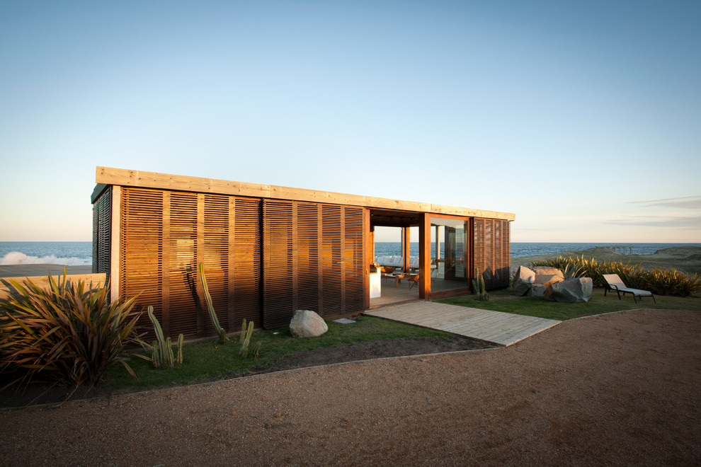 Example of a small minimalist one-story exterior home design in Other