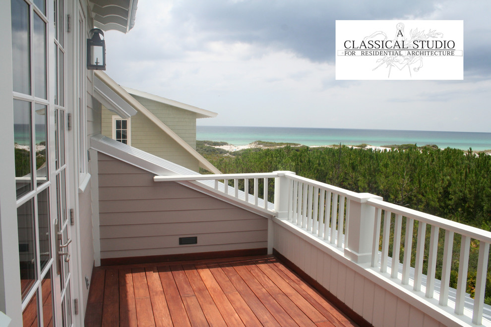 Design ideas for a large and white beach style two floor house exterior in Jacksonville with wood cladding.