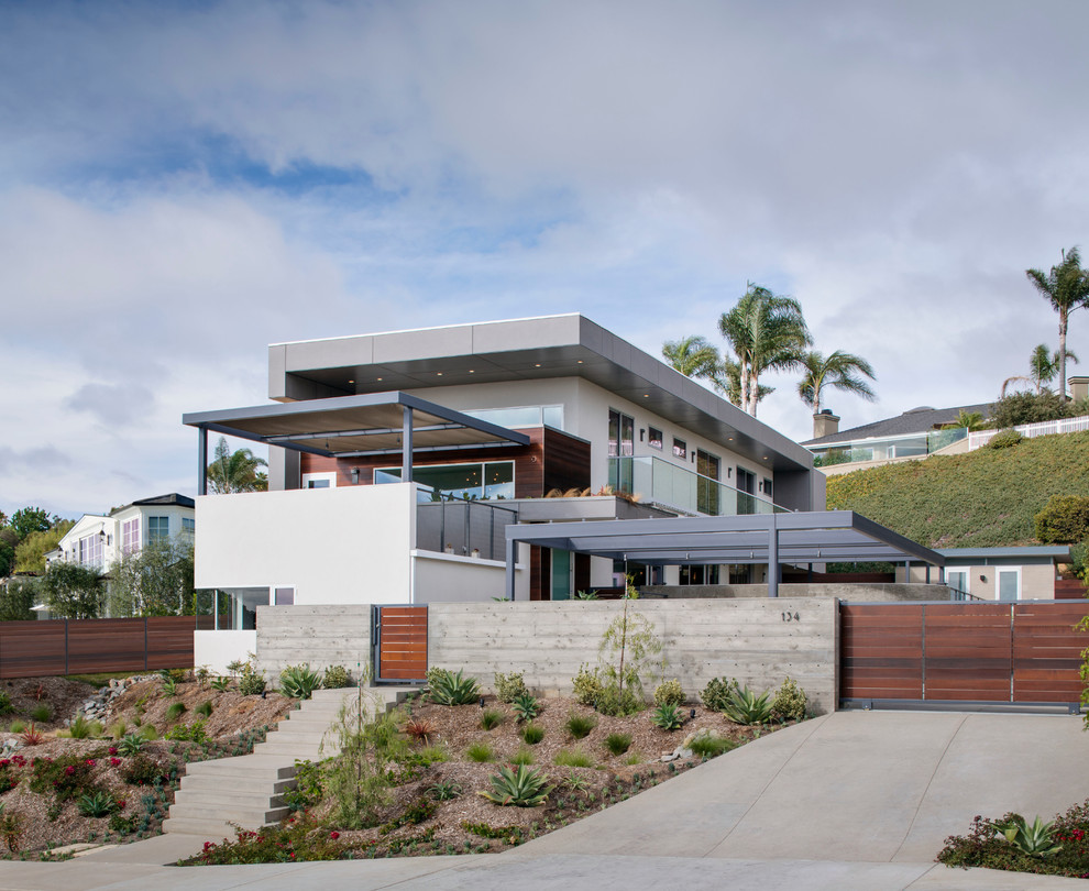 Inspiration for a large beach style split-level house exterior in San Diego with a flat roof.