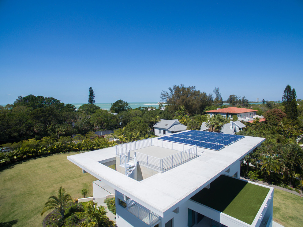 This is an example of a large and multi-coloured nautical detached house in Tampa with three floors, mixed cladding, a flat roof and a mixed material roof.