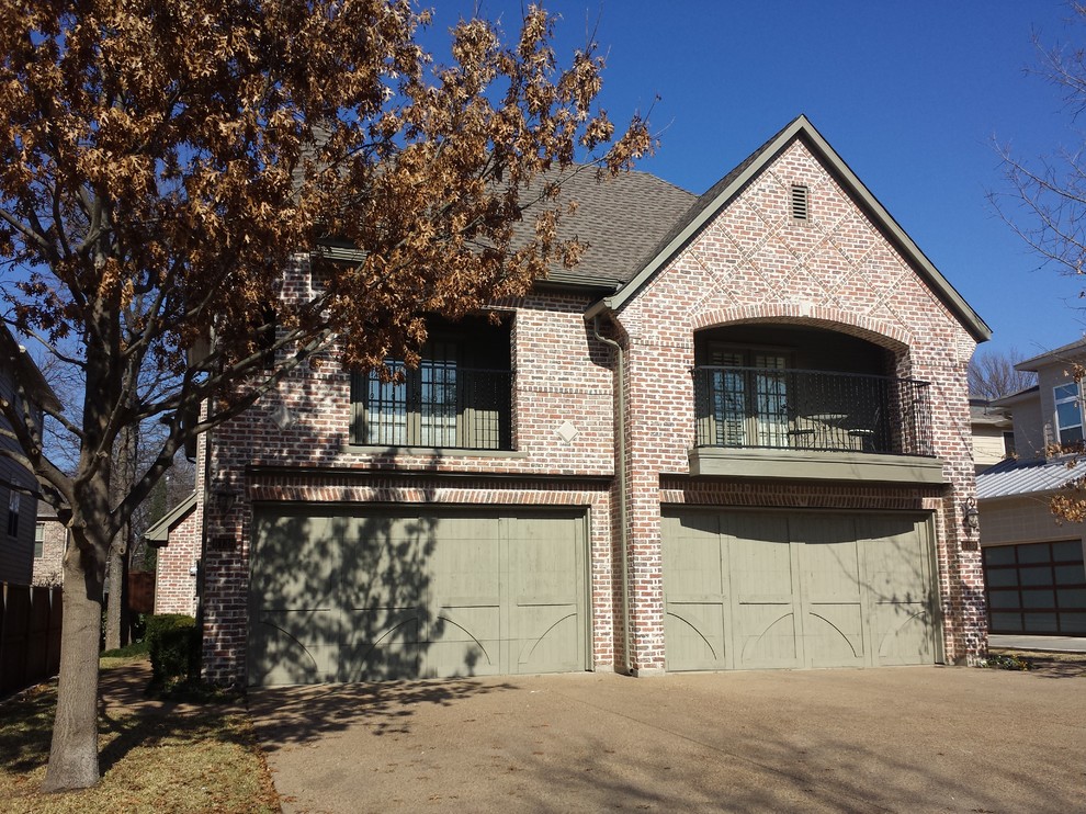 Example of a mid-sized arts and crafts gray two-story brick exterior home design in Dallas