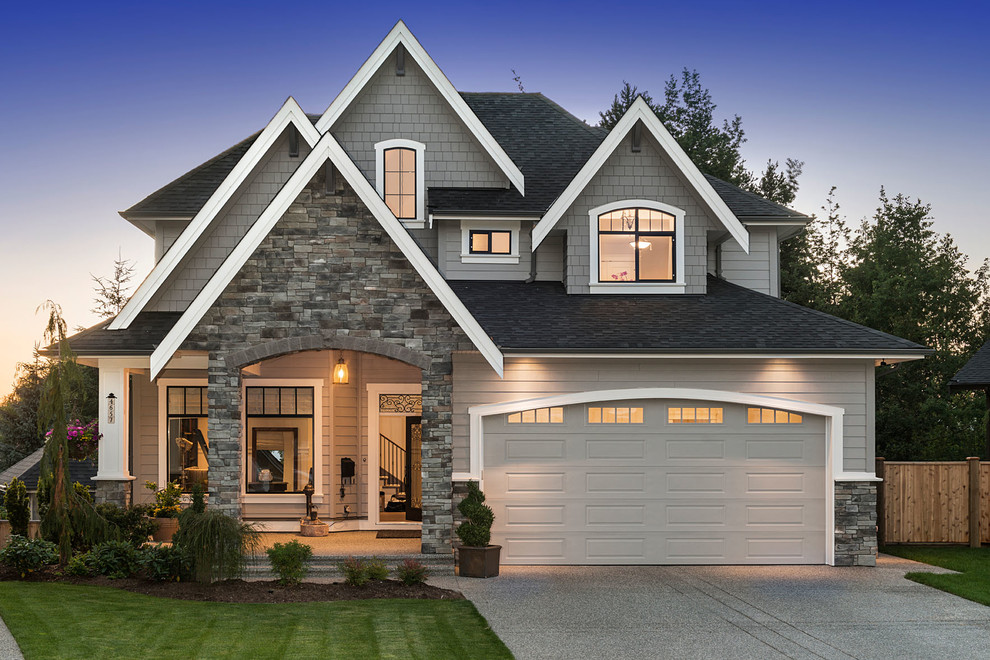 Large transitional beige two-story mixed siding house exterior photo in Vancouver with a hip roof and a shingle roof
