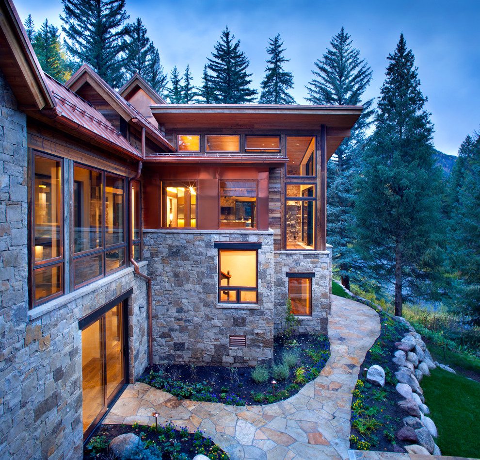 Design ideas for a rustic two floor house exterior in Denver with mixed cladding.